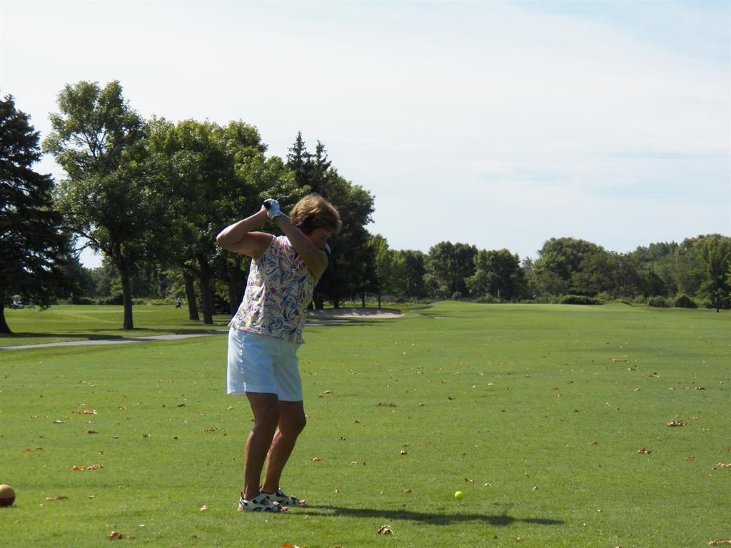 Gerry Moultine is set nicely at the top of her swing to hit one right down the middle.	
